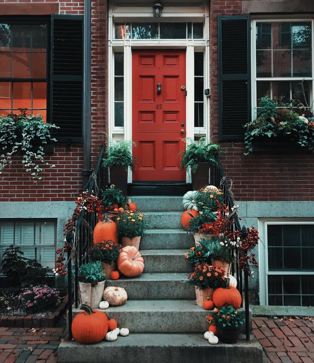 pumpkins on stairs in front of a door
