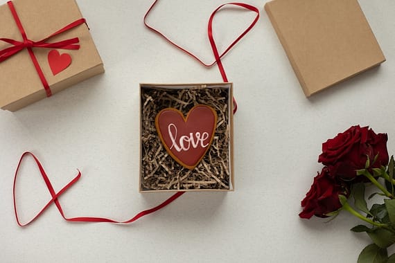 gift boxes with heart shaped cookie and flowers
