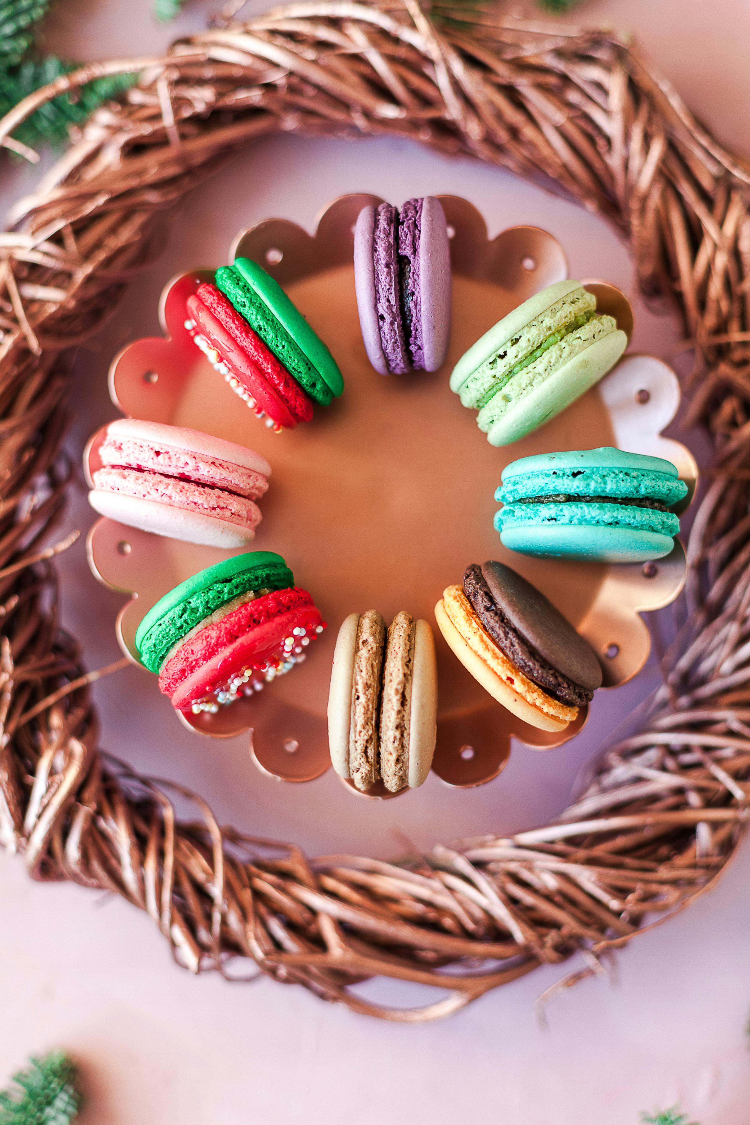 Sweet macaroons on bowl on table